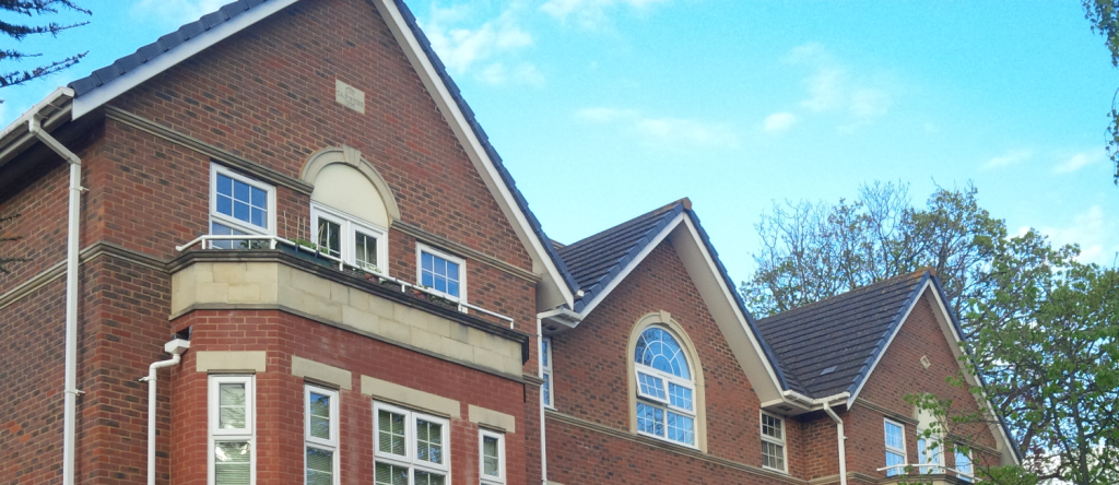 A red brick building with blue sky behind